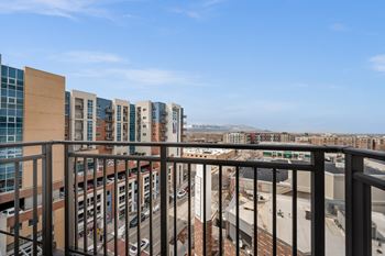 A view from a balcony overlooking a city street.
